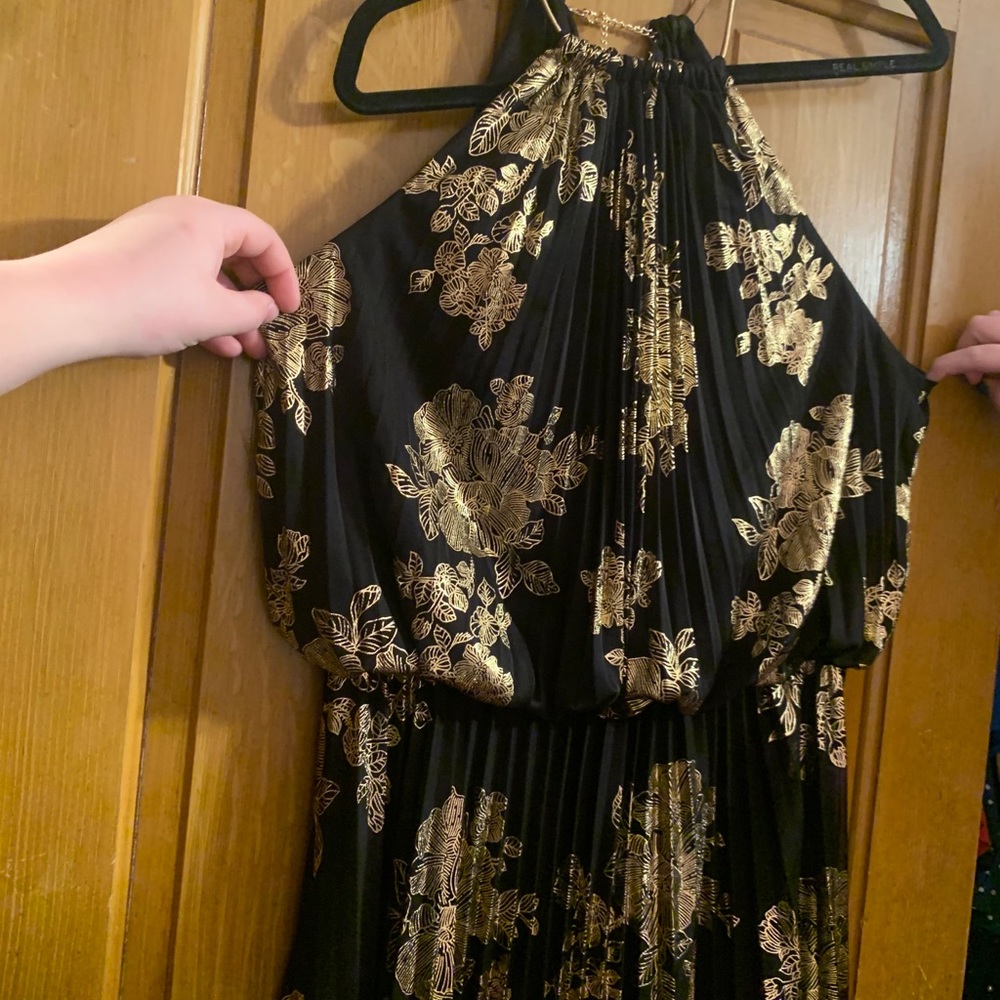 Long black dress with gold detailing.